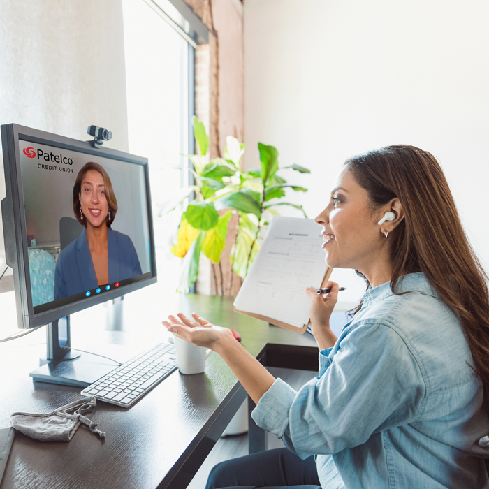 A Patelco Credit Union member in front of their computer enjoying the Virtual Branch services in the comfort of their own home