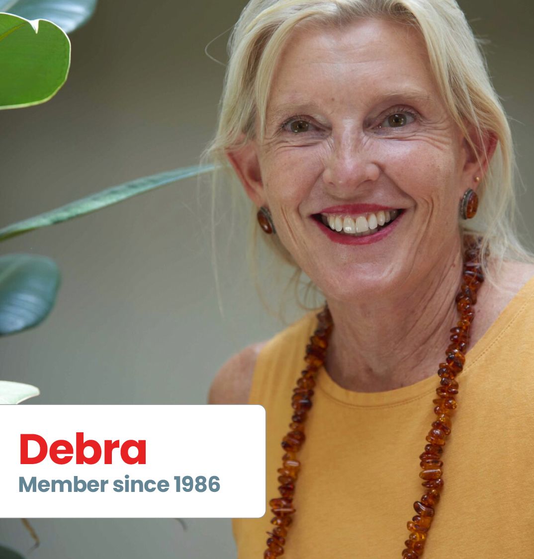 Photo of Patelco member, Debra, looking closely into the camera with a smile