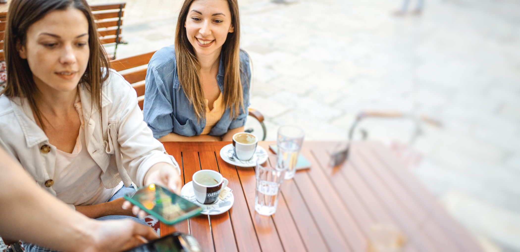 two ladies sitting at a cafe