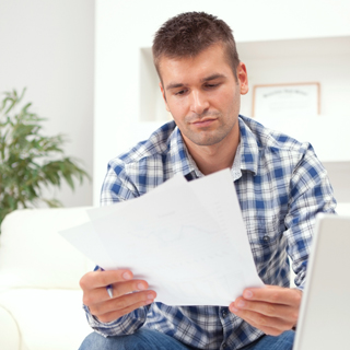 man looking at a piece of paper / paper with list