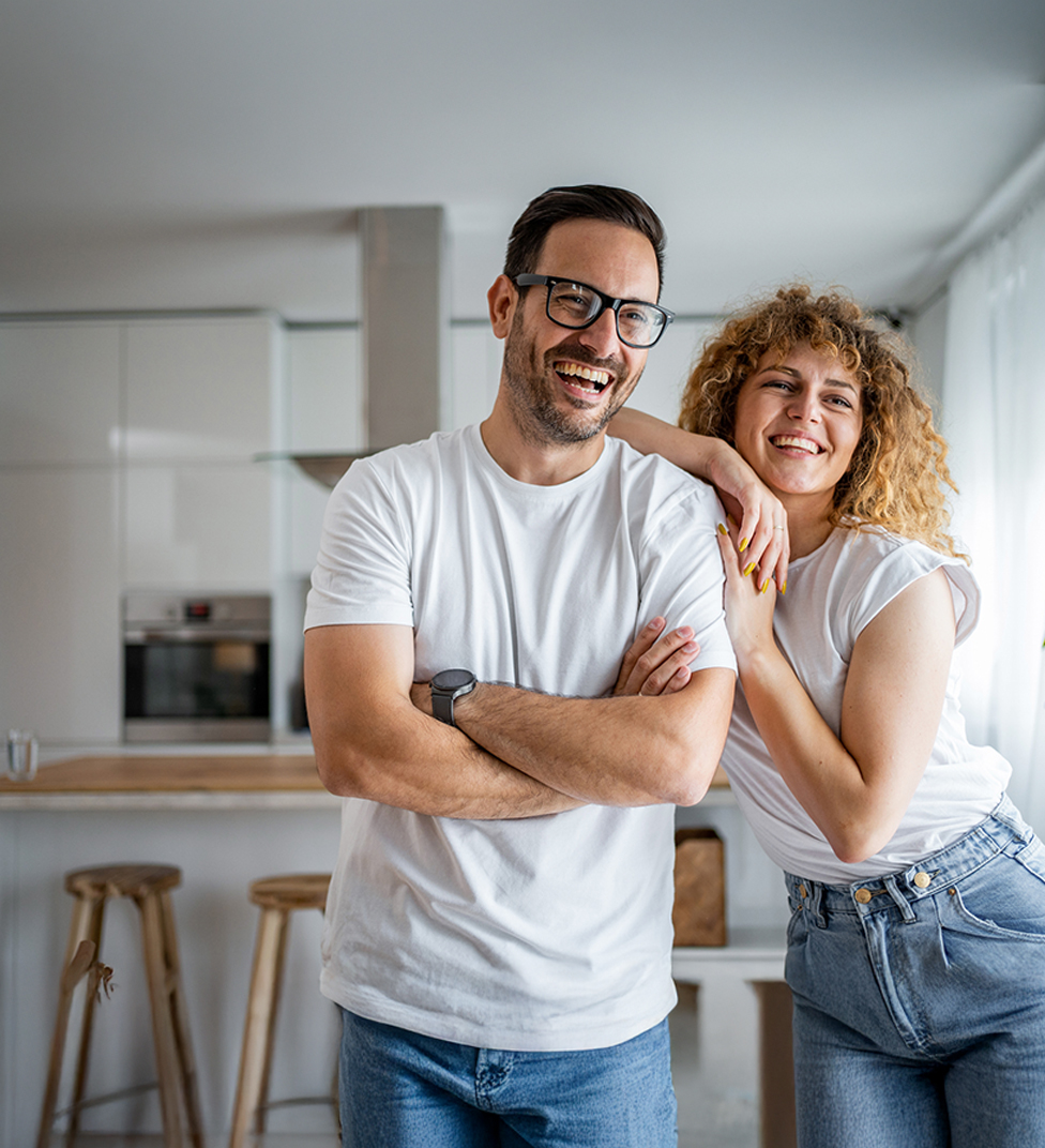 Couple looking away from the camera indoors smiling