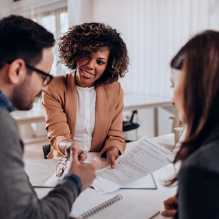 photo of couple or individual talking to a teller or banker