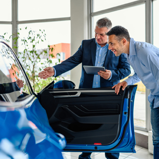 person at a car dealership smiling